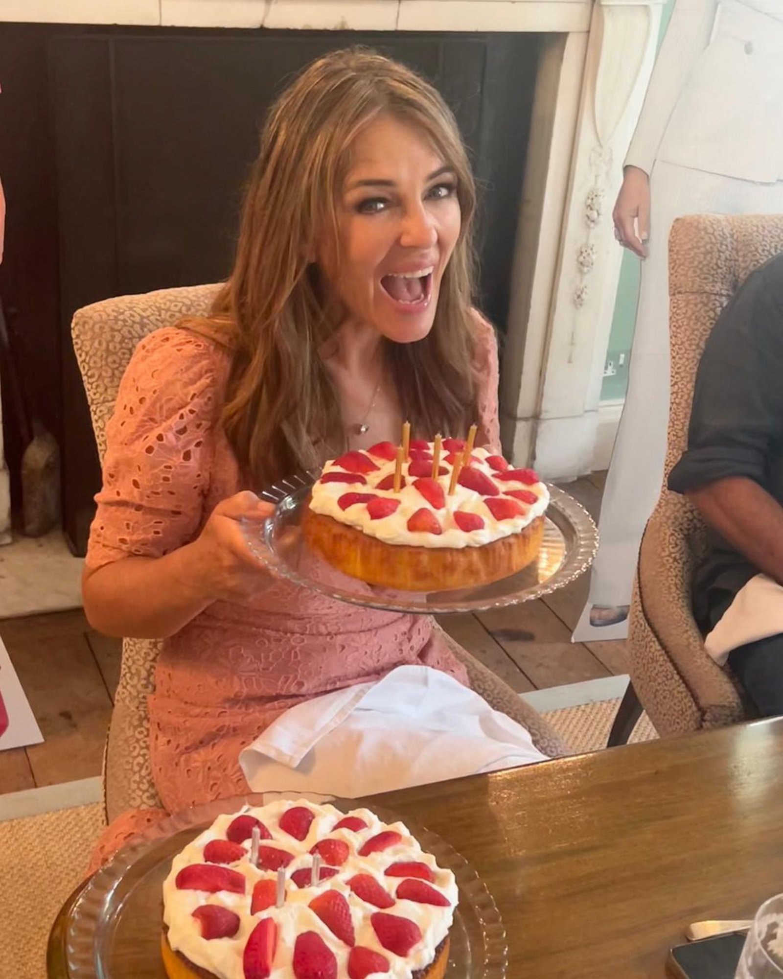Elizabeth Hurley with a cake.