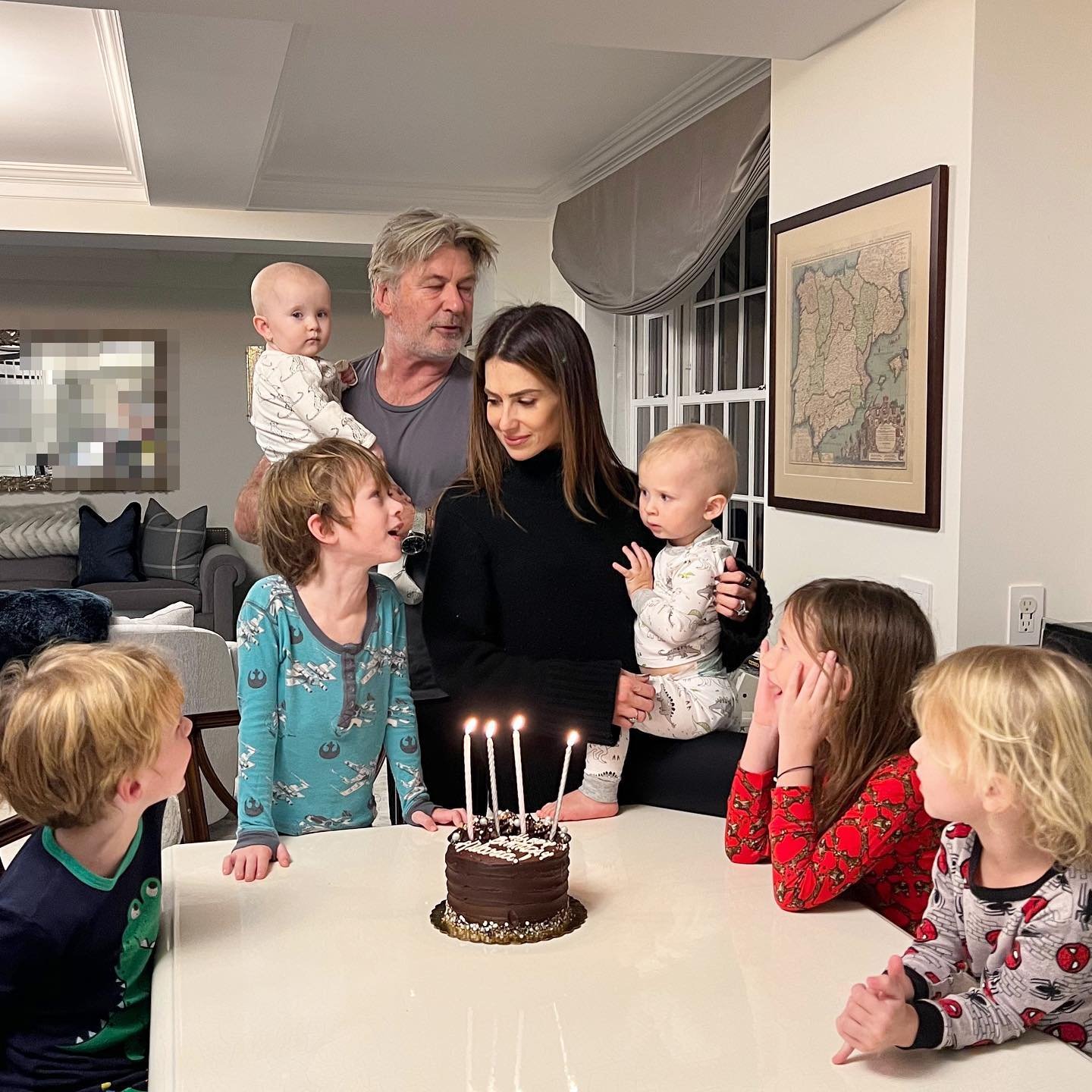 alec and hilaria baldwin with their kids gathered around a birthday cake
