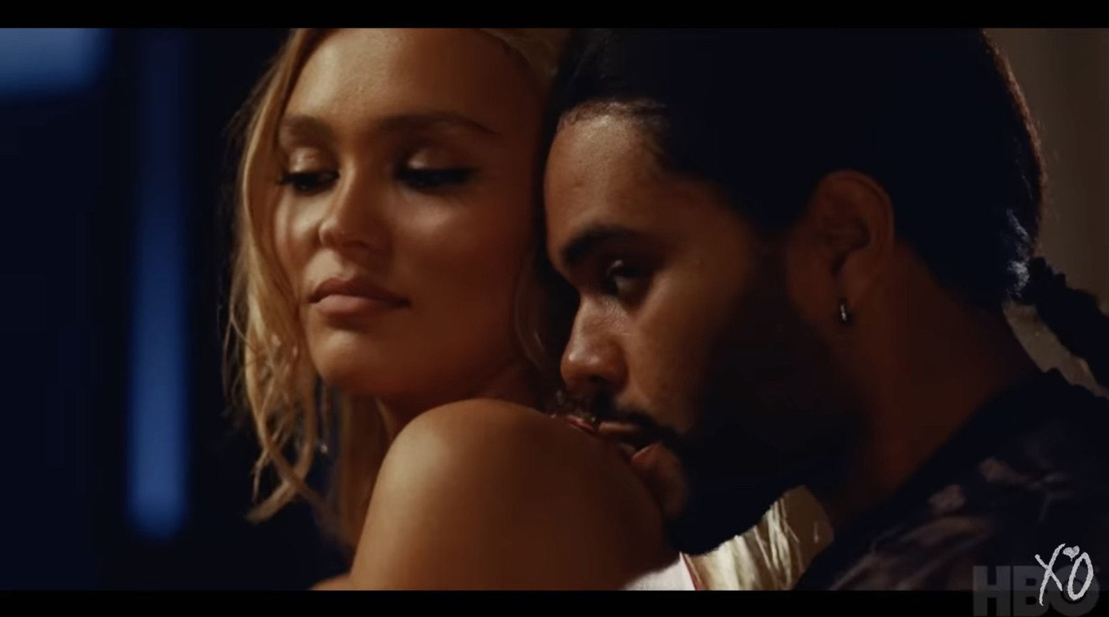 The Weeknd with face against Lily Rose Depps shoulder in "The Idol"