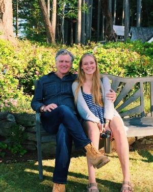 Treat Williams and Ellie Williams sitting together on a bench.