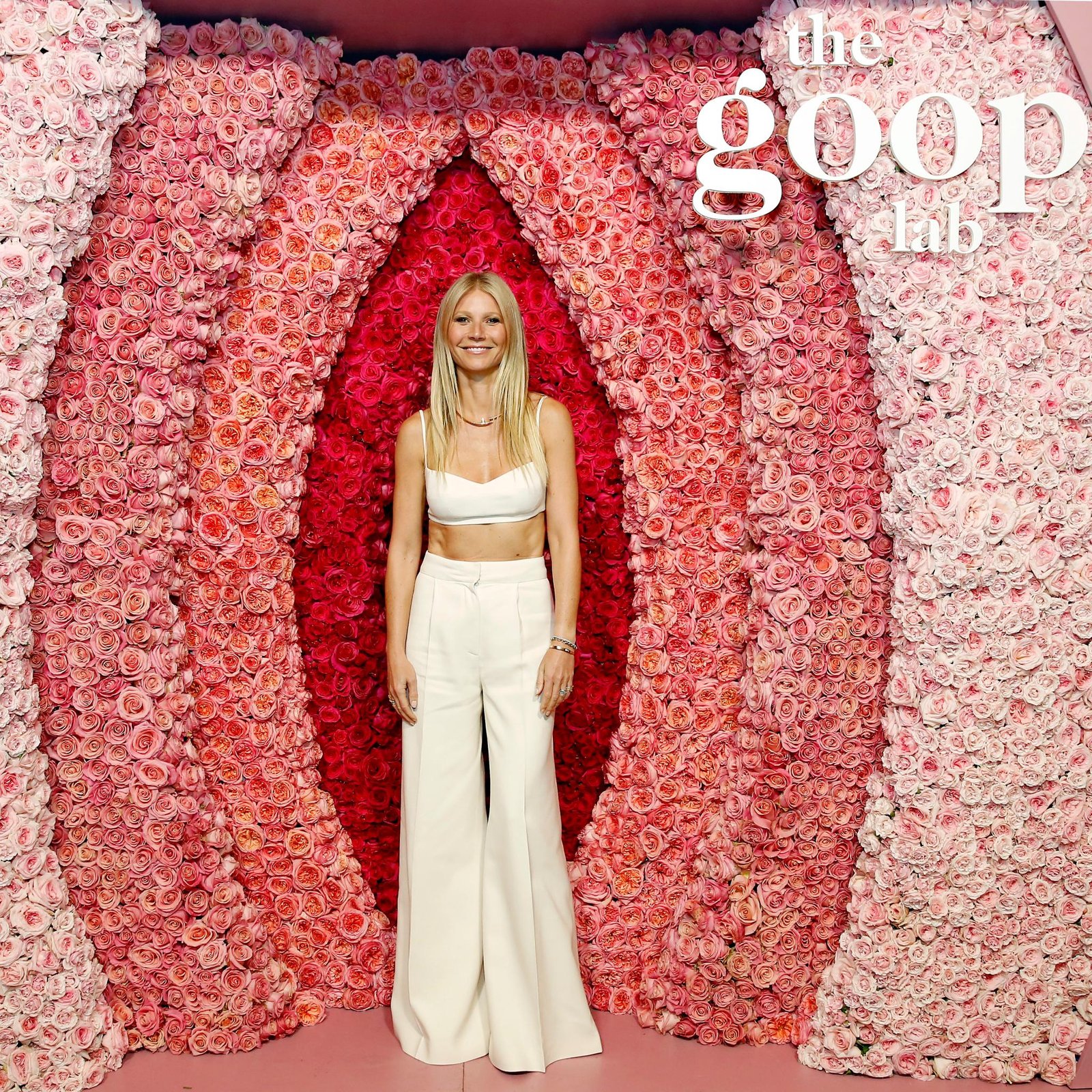 Gwyneth Paltrow in front of a Goop sign.