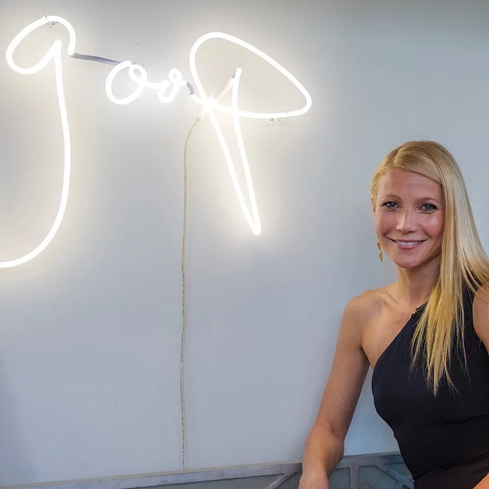 Gwyneth Paltrow with a Goop sign. 