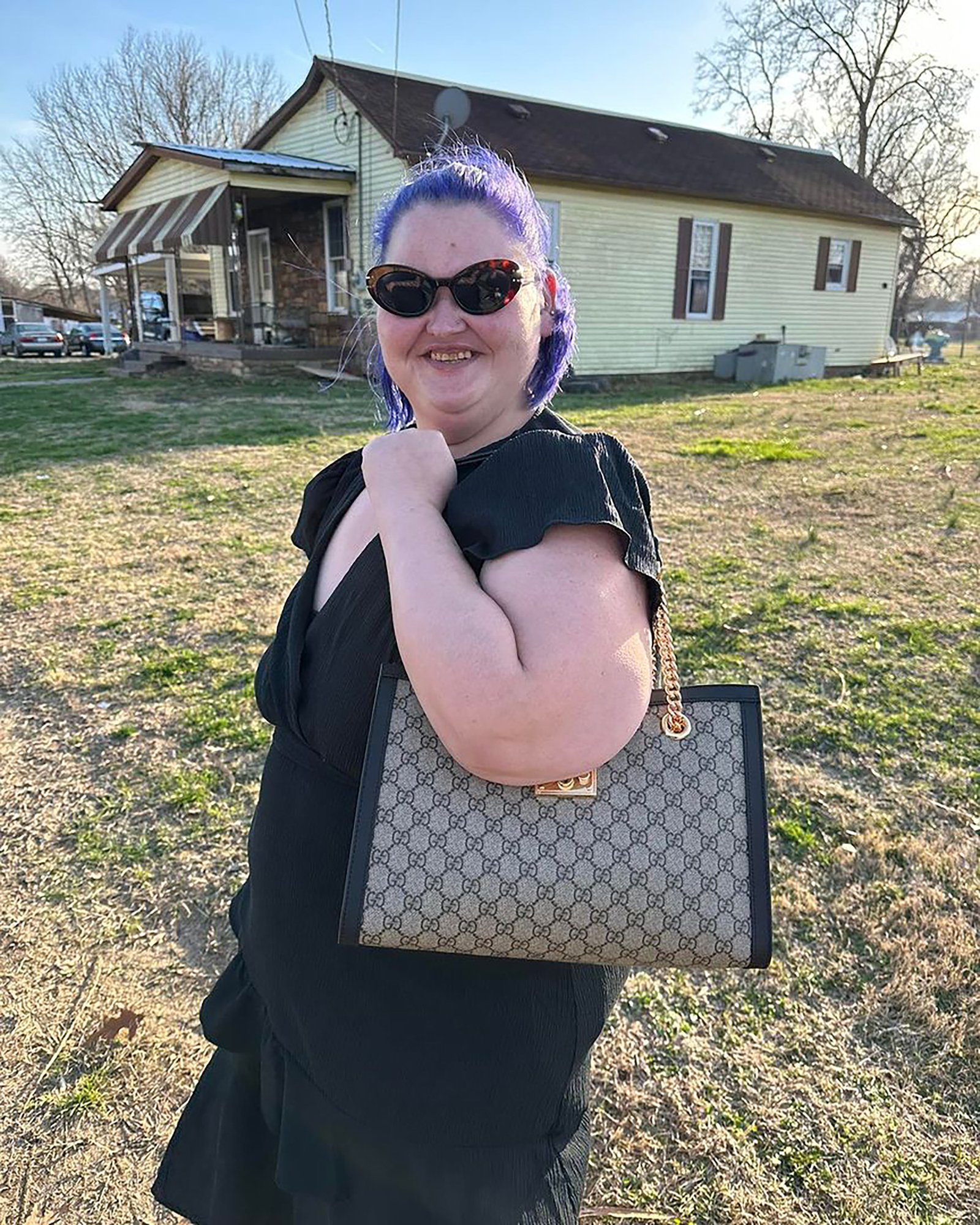Amy Slaton holding a purse.
