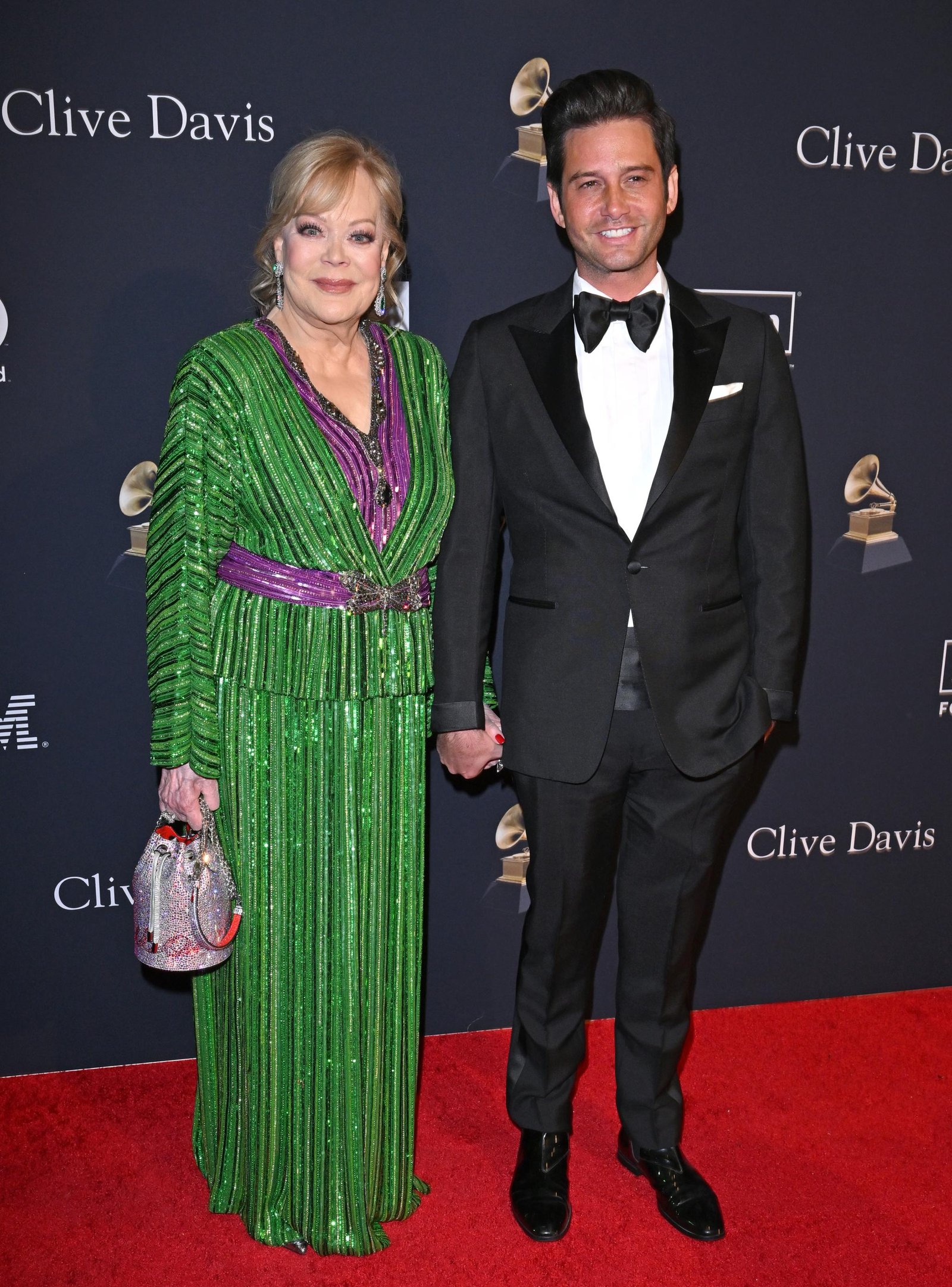 Josh Flagg and Candy Spelling posing together on a red carpet.