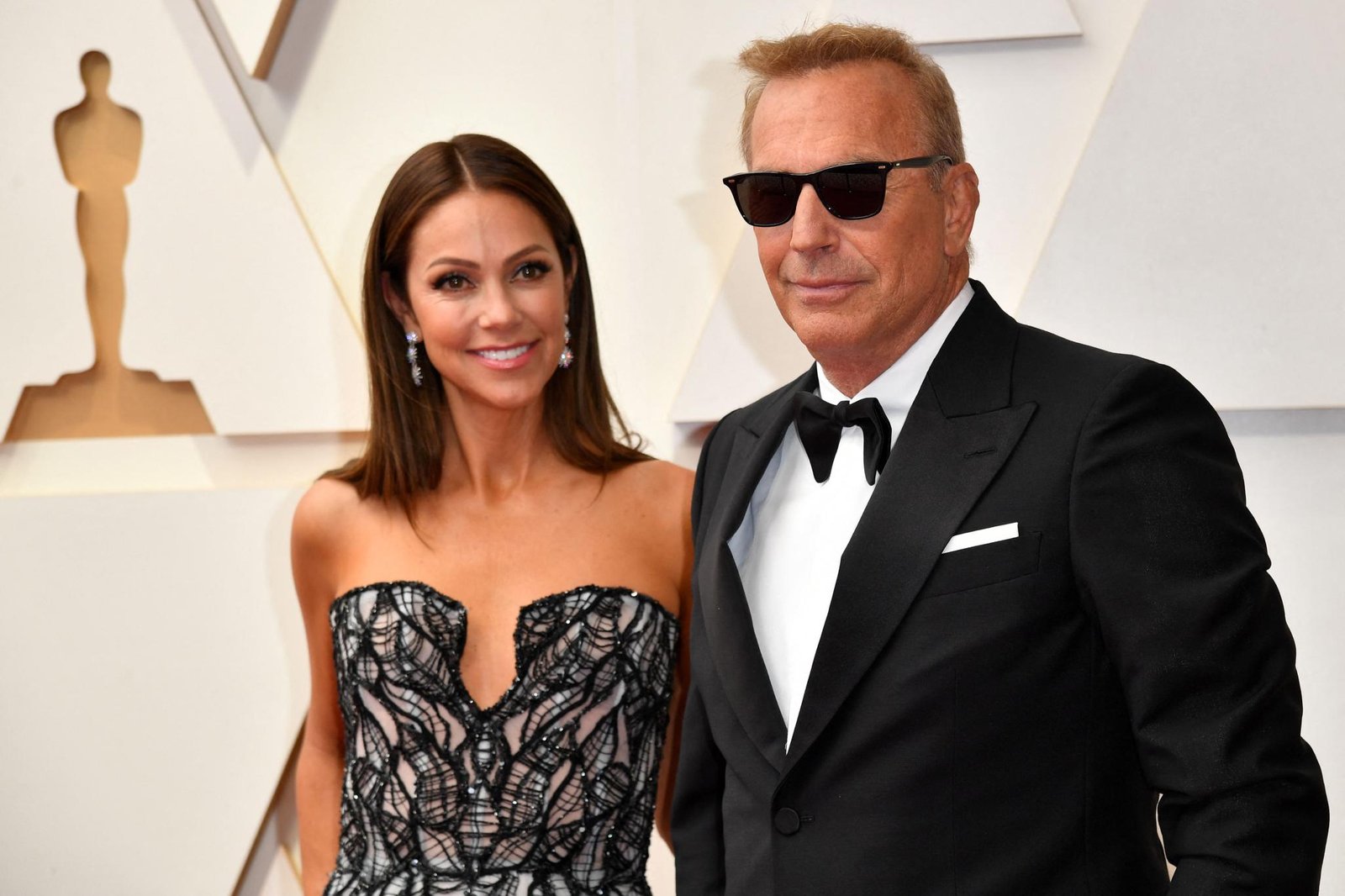 Kevin Costner and Christine Baumgartner at the Oscars in 2022.