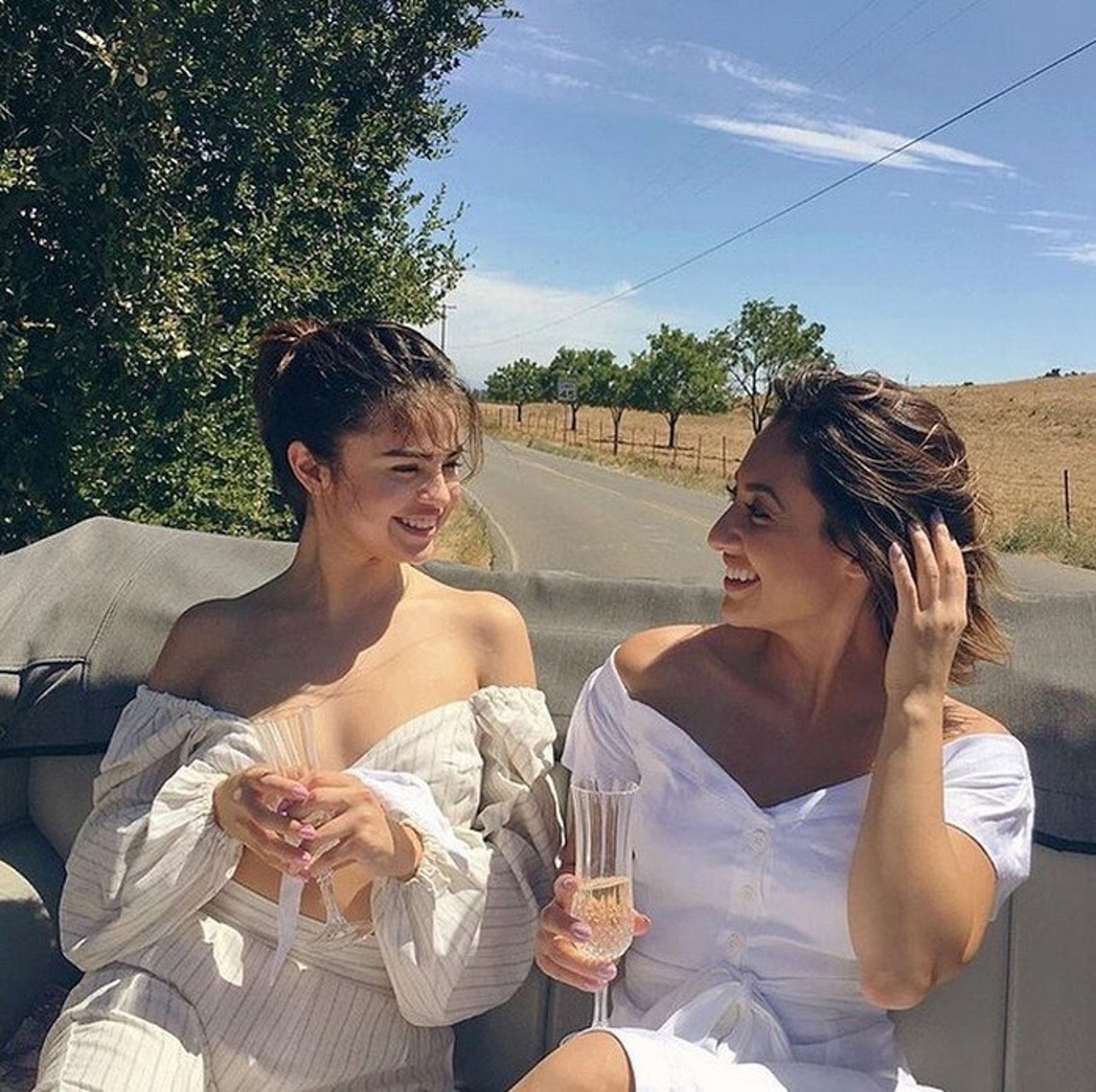 Selena Gomez and Francia Raísa wearing all-white.