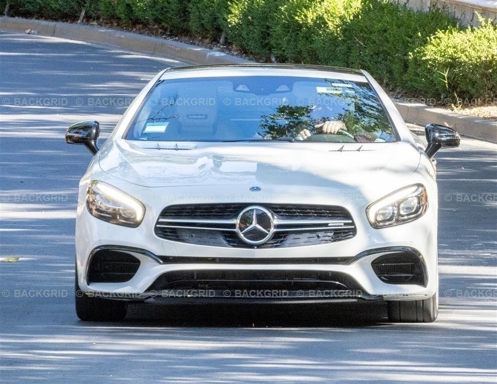 Britney Spears driving a white Mercedes-Benz