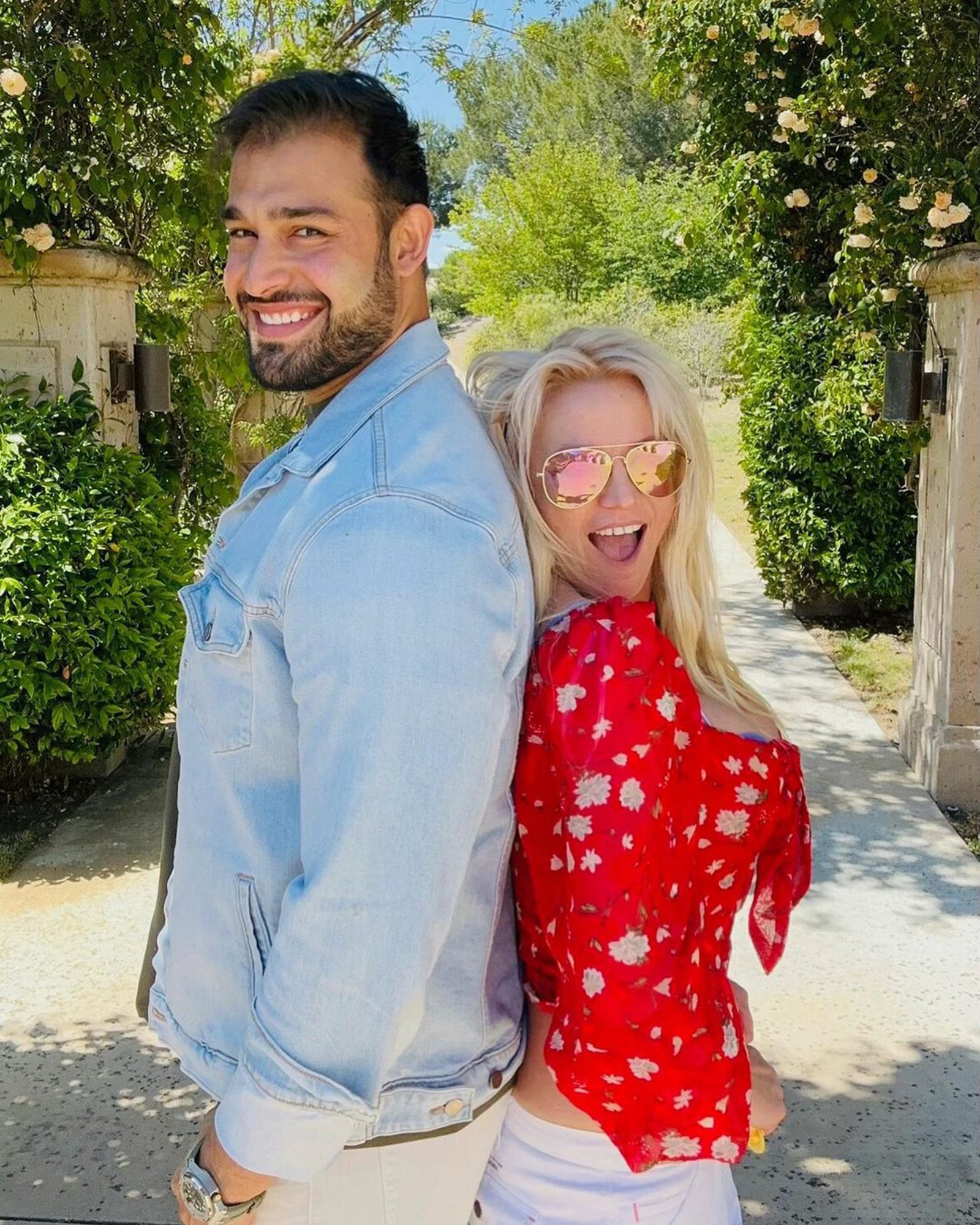 Britney Spears and Sam Asghari standing back to back